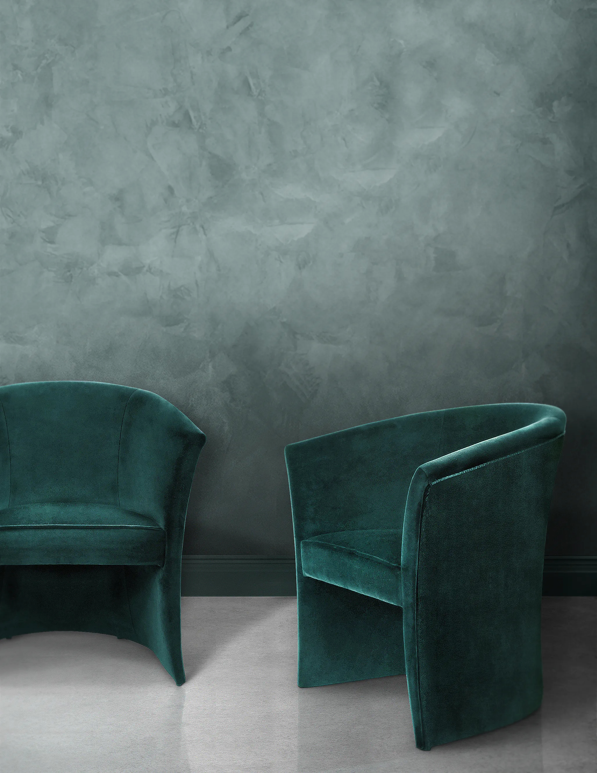 Luxurious Marseille Chairs upholstered in dark forest green velvet with a modern curved design against a minimalist backdrop.