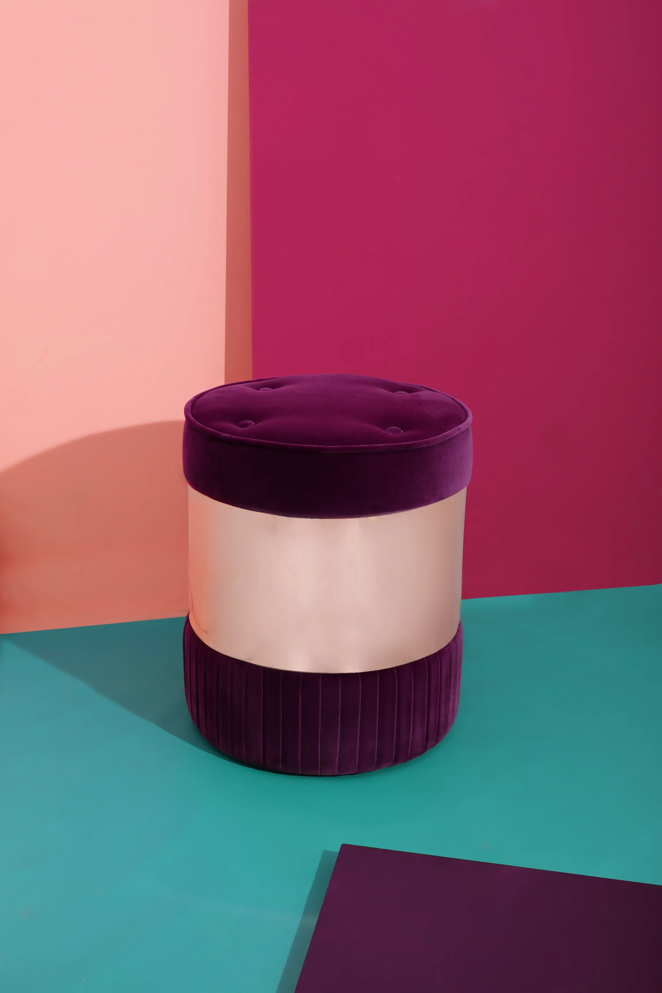 Stylish Seville Pouf by KKbyKOKET with intricate purple upholstery and a soft pink metal ring, set in a modern, colorful space that brings up the mood.